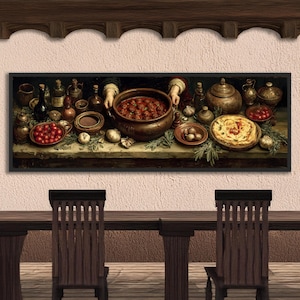 May include: A framed painting depicts a rustic kitchen scene. A large pot of meatballs is held by two hands. Various dishes of food, bottles, and garlic are arranged on a table. The painting is set against a light-colored wall, with wooden beams above and a table and chairs below.