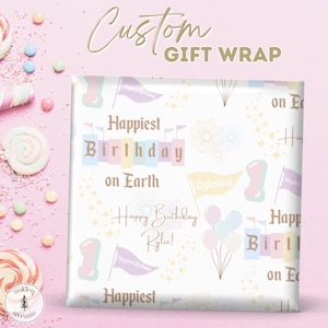 May include: A square gift wrap with a white background and a repeating pattern of birthday-themed graphics. The design includes the text "Happiest Birthday on Earth" and "Happy Birthday Rylie!" in various fonts, along with flags, balloons, and the number "1".