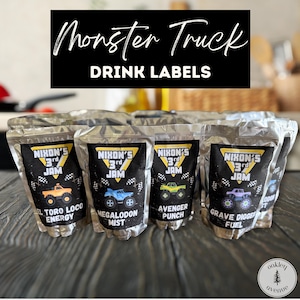 May include: A collection of drink labels in clear pouches, featuring a black banner with the text "Monster Truck DRINK LABELS". Each label has a monster truck graphic and the text "Nixon's 3rd Jam". The labels include "El Toro Loco Energy", "Megalodon Mist", "Avenger Punch", and "Grave Digger Fuel".
