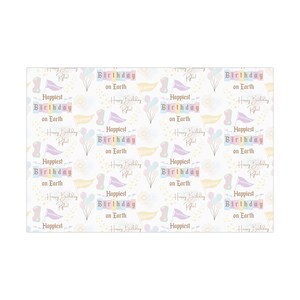 May include: White wrapping paper with a repeating pattern of birthday-themed graphics. The design includes text that reads "Happiest Birthday on Earth," along with flags, balloons, and floral elements in pastel colors.