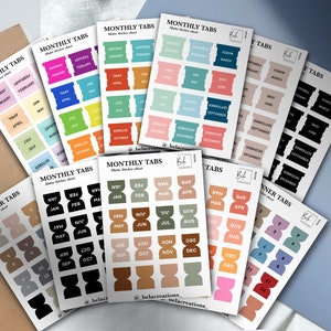 May include: A set of colourful monthly planner tabs with different colour schemes and designs. The tabs are labelled with the months of the year. The tabs are designed to help organise and label planners, notebooks, and other documents.