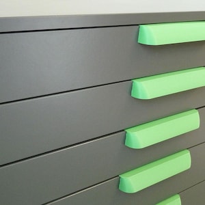 May include: A gray metal dresser with six drawers and green plastic handles.