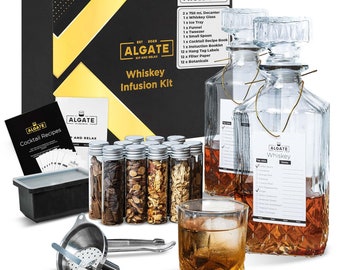 May include: Whiskey infusion kit with a clear glass decanter, 12 small glass vials filled with botanicals, a funnel, a spoon, a tray, and a glass of whiskey. The kit includes 8 botanicals and 4 wood chips. The box is black with gold lettering and the text "ALGATE SIP AND RELAX Whiskey Infusion Kit".