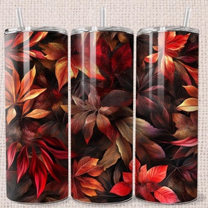 May include: Three stainless steel tumblers with a fall-themed design. The tumblers feature a dark background with red, orange, and yellow leaves.