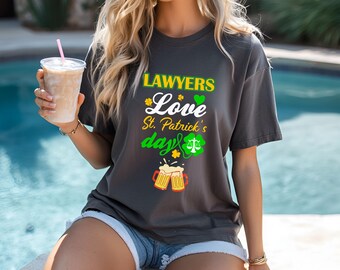 May include: A dark gray t-shirt with the text "LAWYERS Love St. Patrick's day" and a graphic of a beer mug and a scale of justice.