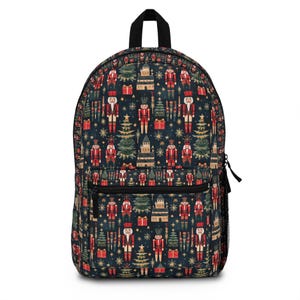 May include: A black backpack with a Christmas nutcracker pattern. The pattern features red, green, and gold nutcrackers, Christmas trees, and presents on a dark blue background.