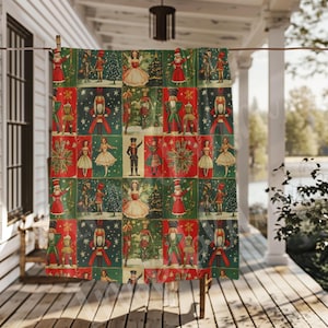 May include: A red, green, and blue patterned fabric shower curtain with a repeating pattern of vintage Christmas illustrations featuring a nutcracker, a ballerina, and a Christmas tree.