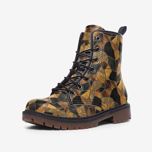 May include: A combat boot with a mosaic pattern in shades of brown, tan, and black. The boot has a lace-up closure with black laces, a rounded toe, and a brown sole. The boot is made of a leather-like material.
