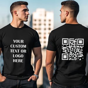 May include: Two black t-shirts, one with a QR code on the back and the other with the text "YOUR CUSTOM TEXT OR LOGO HERE" on the front.