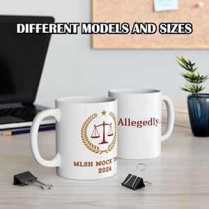 May include: Two white ceramic mugs with a gold and red design. One mug has a scale of justice and a laurel wreath with the text "MLSH Mock Trial 2024". The other mug has the text "Allegedly..." in black.