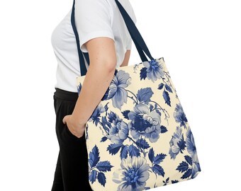 May include: A large tote bag with a cream background and a blue floral pattern. The bag has navy blue straps.