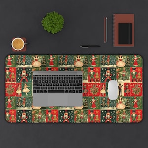 May include: A green and red Christmas-themed mousepad with a repeating pattern of nutcrackers, dancers, and Christmas trees. A laptop computer and a white wireless mouse are on top of the mousepad.