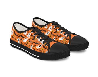 May include: A pair of Halloween-themed canvas sneakers. The orange uppers are patterned with white ghosts, bats, and jack-o'-lanterns. The shoes have black laces, toe caps, and soles, with a white stripe along the sole.