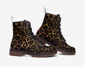 May include: A pair of brown and black leopard print lace-up boots with a chunky sole.