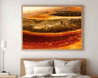 May include: A framed photograph of a colorful landscape with shades of orange, red, and brown. The landscape features a cracked, dry surface with a winding path.