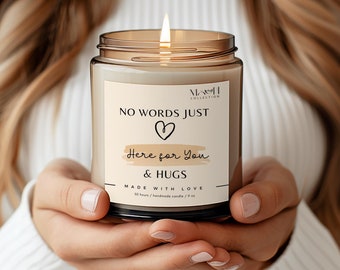 May include: A brown glass candle with a white label that reads "NO WORDS JUST  ♡ Here for You & HUGS MADE WITH LOVE 50 hours handmade candle / 9 oz".