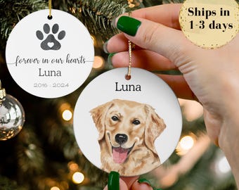 May include: White ceramic ornament with a paw print and the text "forever in our hearts Luna 2016-2024." Another ornament features a watercolor portrait of a golden retriever and the name "Luna."