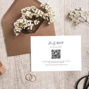 May include: White card with black text that reads "Kindly RSVP by 1st June 2025". A black and white QR code is below the text. The text below the QR code reads "Please scan for more details and to RSVP to our wedding website www.weddingwebsitehere.com.au"
