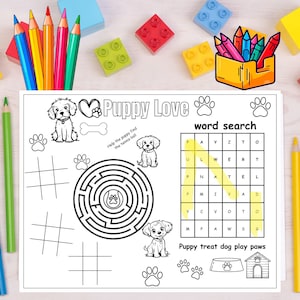 May include: A black and white Puppy Love activity sheet with a word search, maze, tic-tac-toe, and puppy illustrations. Includes a yellow pencil box with colored pencils and colorful building blocks.