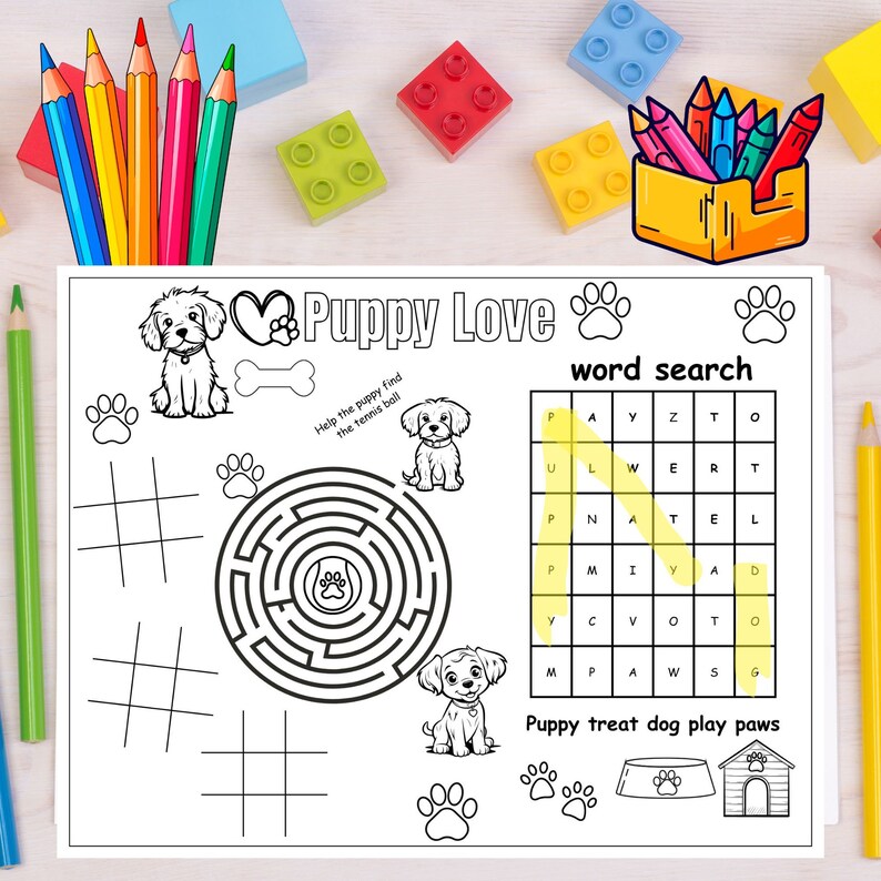 May include: A black and white Puppy Love activity sheet with a word search, maze, tic-tac-toe, and puppy illustrations. Includes a yellow pencil box with colored pencils and colorful building blocks.