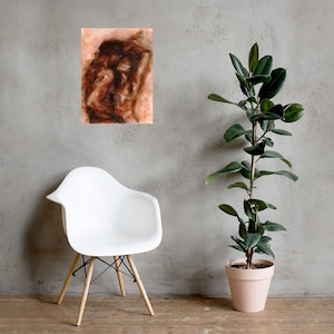 May include: An abstract art print featuring a brown and tan color palette. The artwork is displayed on a wall above a white chair with wooden legs. A tall potted plant with green leaves is to the right of the chair.