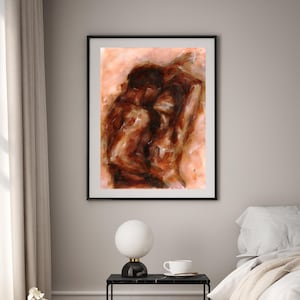 May include: Abstract art print in a black frame. The artwork features a warm color palette of browns and tans, depicting figures in an embrace. The painting has a textured, expressive style, suitable for home decor.