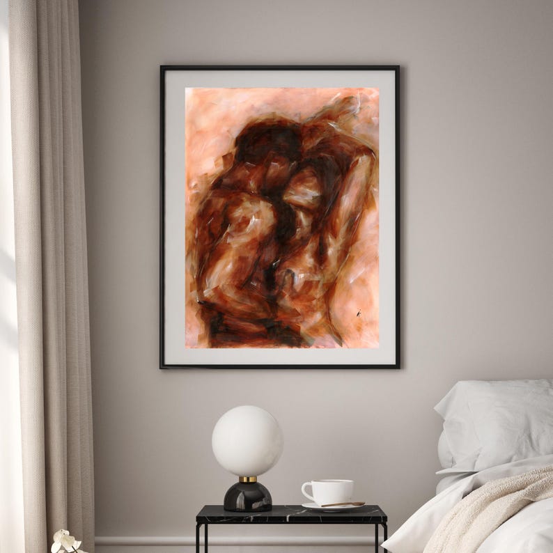 May include: Abstract art print in a black frame. The artwork features a warm color palette of browns and tans, depicting figures in an embrace. The painting has a textured, expressive style, suitable for home decor.