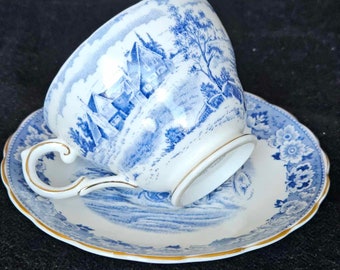 Royal tuscan signed a tea cup and saucer,  country style,  village scene. Blue blanch porcelain England Bone China