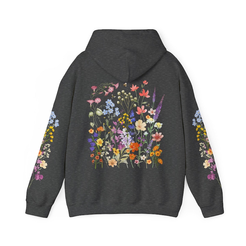 May include: A dark gray hooded sweatshirt with a colorful floral print on the back. The print features a variety of flowers in shades of pink, purple, yellow, and orange.