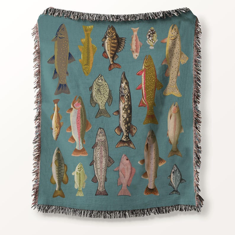 May include: Teal throw blanket featuring a pattern of various fish illustrations in shades of brown, yellow, pink, and gray. The blanket has a fringed edge and is suitable for home decor.