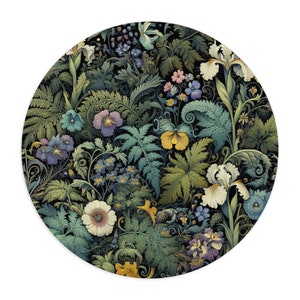 May include: Round floral design featuring a dense arrangement of flowers and foliage in shades of green, blue, yellow, and purple against a black background. The design includes irises, pansies, and ferns.