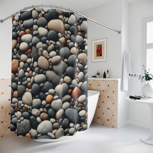 May include: A shower curtain featuring a close-up image of a variety of smooth, round stones in shades of gray, brown, and beige.