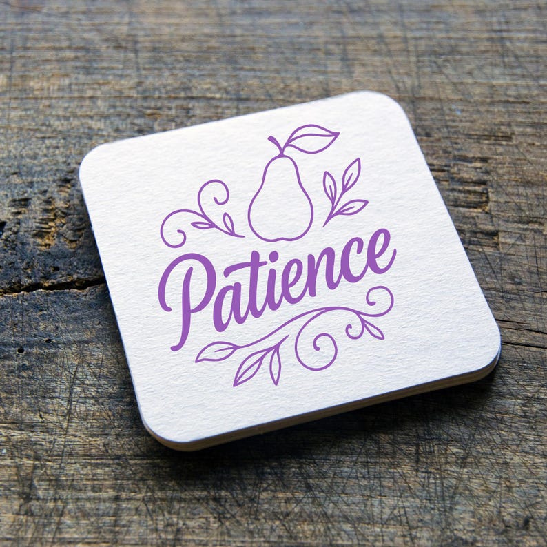 May include: Square white coaster with the word "Patience" in a purple script font, along with a pear illustration and decorative leaves. The coaster is on a wooden surface.