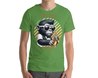 May include: Green t-shirt with a cartoon illustration of a monkey wearing sunglasses and playing a saxophone. The text "CRAZY JAZZY" is printed on the shirt.
