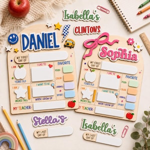 May include: Two arched wooden boards for school milestones featuring the names Daniel and Sophia in blue and pink. Each board includes sections for My First Day Of, I Am, I Like To, Favorite, and My Teacher, with icons like apples, stars, and a school bus.