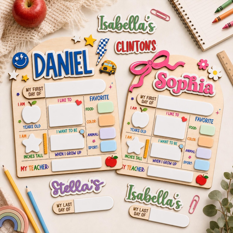 May include: Two arched wooden boards for school milestones featuring the names Daniel and Sophia in blue and pink. Each board includes sections for My First Day Of, I Am, I Like To, Favorite, and My Teacher, with icons like apples, stars, and a school bus.