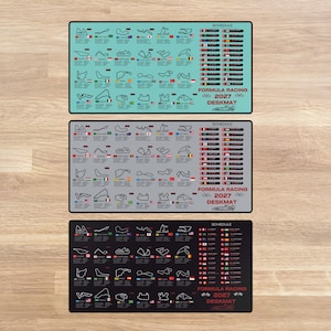May include: Three rectangular desk mats in light blue, gray, and black, each featuring a 2027 Formula Racing schedule. The designs include outlines of various international race tracks, national flags, and a list of race dates and locations.