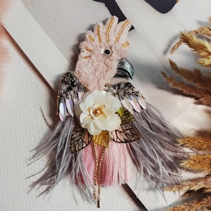 Pink beaded cockatoo parrot brooch, a bird with shimmering feathers and a sequin flower
