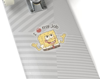 May include: A skateboard with a gray and white striped pattern. A sticker of Spongebob Squarepants with the text "I ♥ my job" is on the skateboard.