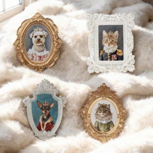 May include: Four ornate picture frames containing portraits of pets dressed in royal attire. The top left is a gold oval frame with a dog in a crown and pearls. The top right is a white rectangular frame with a cat in a military uniform. The bottom left is a silver shield-shaped frame with a dog in a red cape. The bottom right is a gold oval frame with a cat in a crown.
