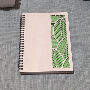 A5 wooden, 80-page notebook, with a vibrant “leaf” inspired geometric pattern against your choice of coloured card inlay.