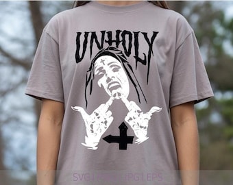 May include: A light gray short-sleeve t-shirt featuring a black and white graphic print. The design displays the word UNHOLY in a stylized font above an illustration of a nun with a cross on her forehead, gesturing with both middle fingers.