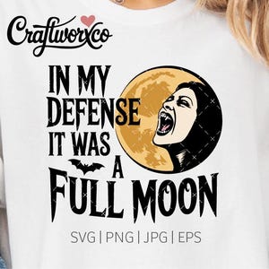 May include: White t-shirt with a black graphic design. The design includes the text "IN MY DEFENSE IT WAS A FULL MOON" with a bat and a woman's face in front of a full moon. The Craftworxco logo is at the top.