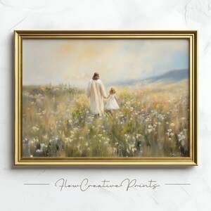 May include: A framed painting depicting a man and a young girl walking through a field of wildflowers. The man is wearing a white robe and the girl is wearing a white dress. The painting is set against a backdrop of a blue sky and green hills.