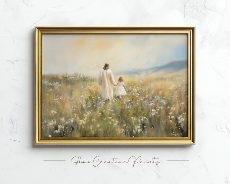 May include: A framed painting depicting a man and a young girl walking through a field of wildflowers. The man is wearing a white robe and the girl is wearing a white dress. The painting is set against a backdrop of a blue sky and green hills.