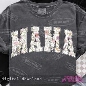 May include: Dark gray sweatshirt with the word "MAMA" in large, white, floral-patterned letters. The floral design includes pink, purple, and orange flowers. The words "digital download" are at the bottom.