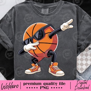 May include: Dark grey sweatshirt with a cartoon basketball character wearing sunglasses and orange trainers, dabbing. The basketball is orange with black lines. The text "Woldero | premium quality file | Digital Download" is at the bottom.