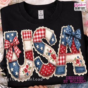 May include: Black sweatshirt featuring the word "USA" in a patchwork design. The letters are adorned with bows, floral details, and star patterns in red, white, and blue. The design also includes the text "digital download" and "DESIGNED BY WOLDERO".