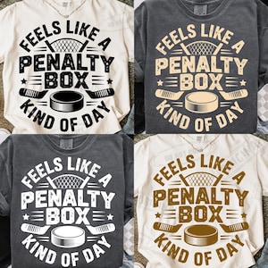 May include: Four t-shirts with the text "Feels Like A Penalty Box Kind of Day". The design includes a hockey net, hockey sticks, and a hockey puck. The shirts are in various colors, including white, grey, and tan.