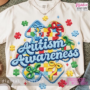May include: White t-shirt with a colorful Autism Awareness design. The design features a blue, cursive "Autism Awareness" text, surrounded by puzzle pieces and decorative elements in various colors. The shirt also has the text "digital download".